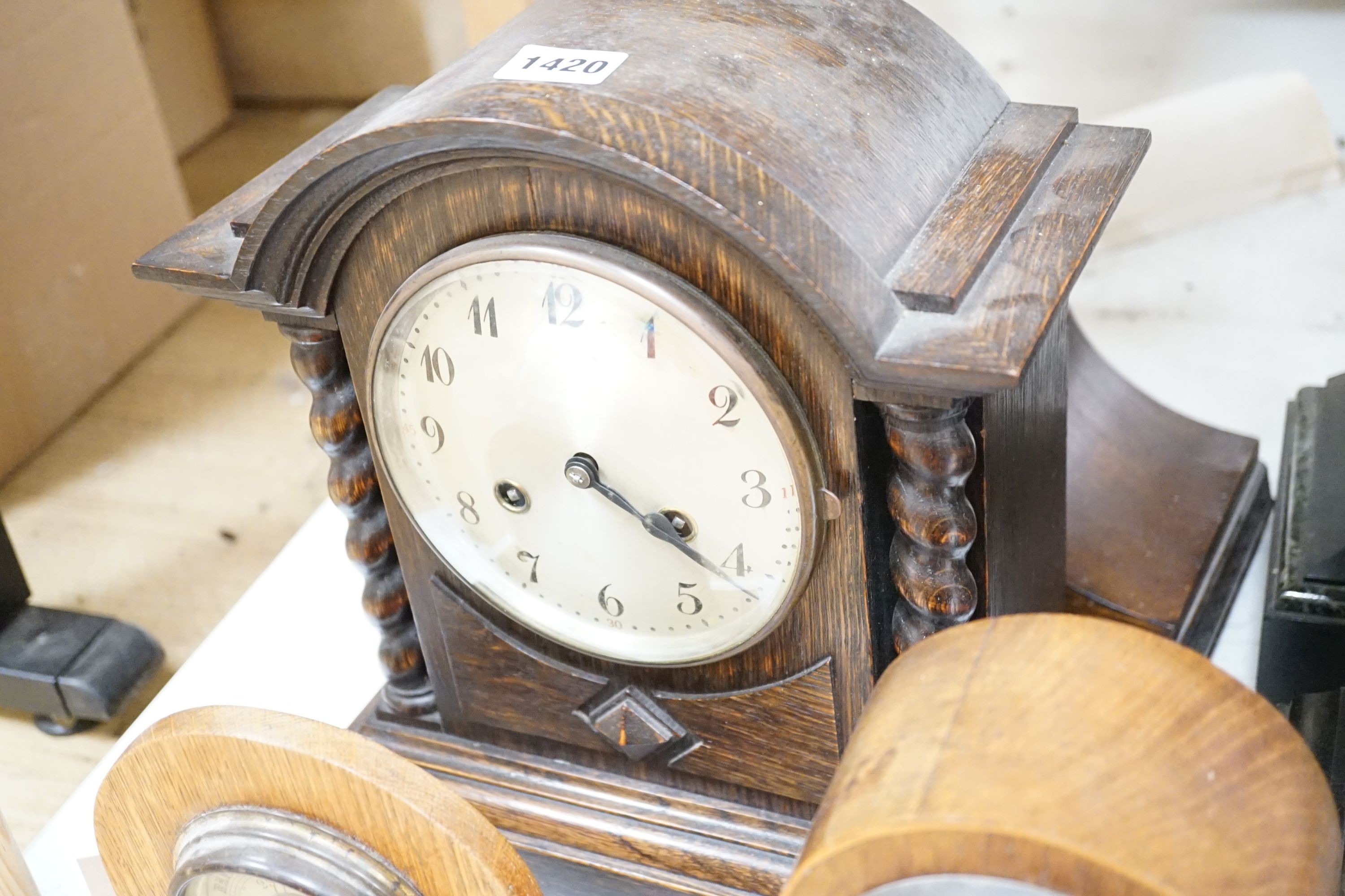 Two 19th century slate mantel clocks, three Edwardian and later wooden mantel clocks and a barometer, tallest 31 cms high.